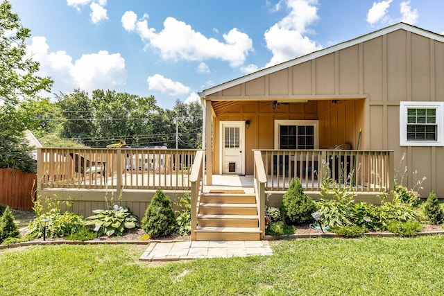 305 Bryant St, Watertown, TN 37184 - view of front of home featuring board and batten siding, a front yard, and a wooden deck