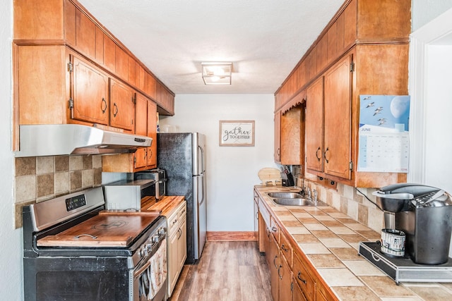 305 Bryant St, Watertown, TN 37184 - kitchen with stainless steel appliances, under cabinet range hood, tile counters, and decorative backsplash
