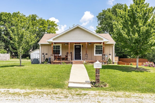305 Bryant St, Watertown, TN 37184 - bungalow featuring ceiling fan, covered porch, board and batten siding, a storage unit, and a shingled roof