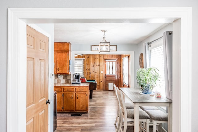 305 Bryant St, Watertown, TN 37184 - kitchen featuring light wood finished floors, brown cabinetry, light countertops, and pendant lighting