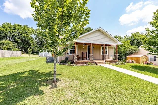305 Bryant St, Watertown, TN 37184 - view of front of home with covered porch, a storage shed, ceiling fan, and board and batten siding