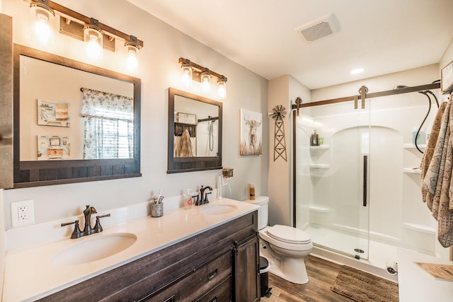 305 Bryant St, Watertown, TN 37184 - bathroom with a shower stall, double vanity, and wood finished floors
