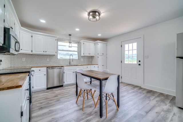 4819 Whites Creek Pike, Whites Creek, TN 37189 - kitchen featuring butcher block counters, black microwave, stainless steel dishwasher, light wood-type flooring, and recessed lighting