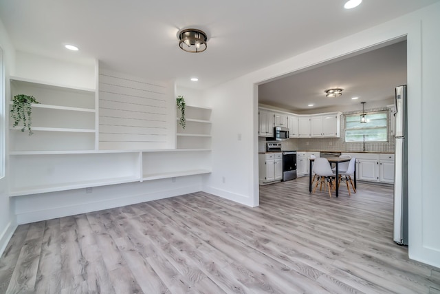 4819 Whites Creek Pike, Whites Creek, TN 37189 - kitchen with appliances with stainless steel finishes, white cabinets, light wood finished floors, recessed lighting, and backsplash
