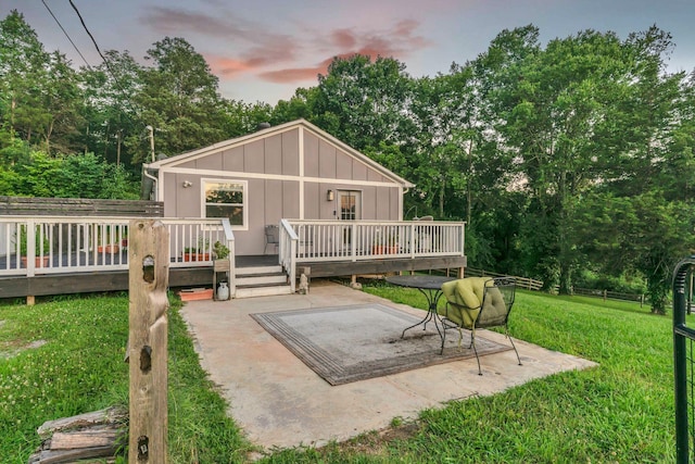 4819 Whites Creek Pike, Whites Creek, TN 37189 - back of property at dusk featuring board and batten siding, a yard, a wooden deck, a patio, and view of scattered trees