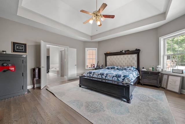 3723 Reed Rd, Indian Mound, TN 37079 - bedroom featuring a tray ceiling, wood finished floors, ensuite bathroom, and a ceiling fan