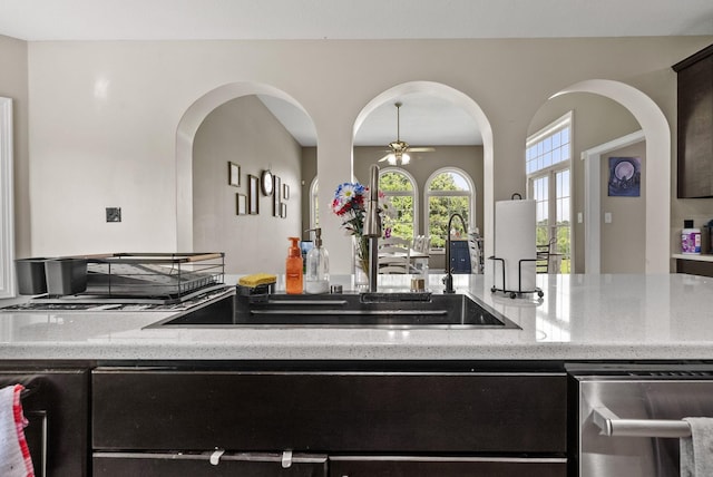 3723 Reed Rd, Indian Mound, TN 37079 - kitchen featuring stainless steel dishwasher, light stone counters, ceiling fan, and arched walkways