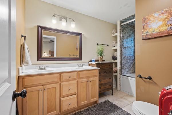 414 Grace St, Springfield, TN 37172 - bathroom featuring double vanity, tile patterned floors, and shower / washtub combination