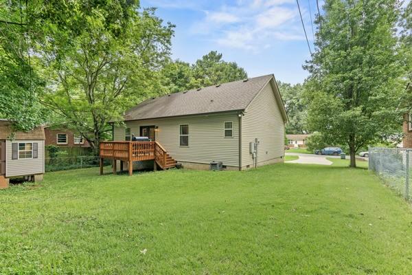 414 Grace St, Springfield, TN 37172 - rear view of house featuring a wooden deck, crawl space, and an outbuilding
