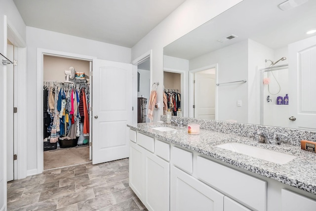 124 Nunally Dr, Baxter, TN 38544 - full bathroom with a walk in closet, double vanity, and a stall shower