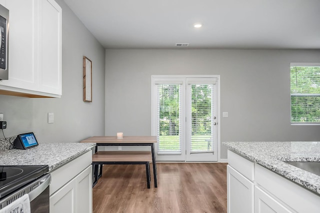 124 Nunally Dr, Baxter, TN 38544 - kitchen featuring healthy amount of natural light, white cabinetry, light wood finished floors, light stone countertops, and recessed lighting