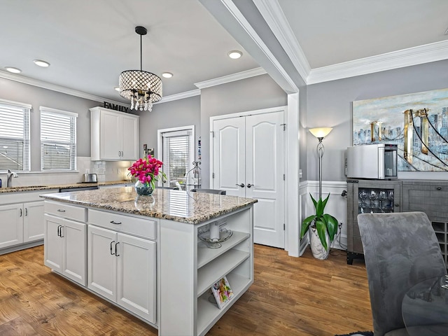 141 Tipton Pass, Spring Hill, TN 37174 - kitchen with open shelves, a chandelier, healthy amount of natural light, white cabinetry, and crown molding