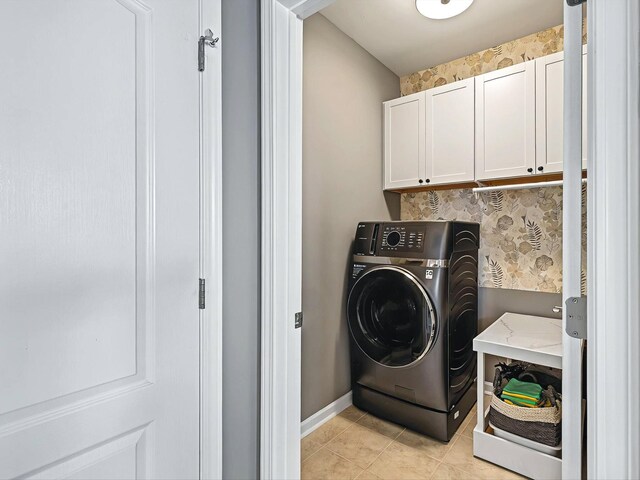 141 Tipton Pass, Spring Hill, TN 37174 - laundry area featuring washer / clothes dryer, cabinet space, and light tile patterned floors