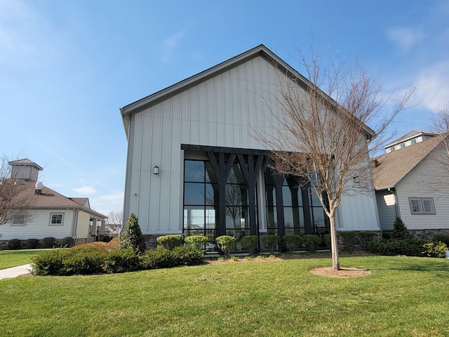 141 Tipton Pass, Spring Hill, TN 37174 - rear view of house featuring board and batten siding and a yard