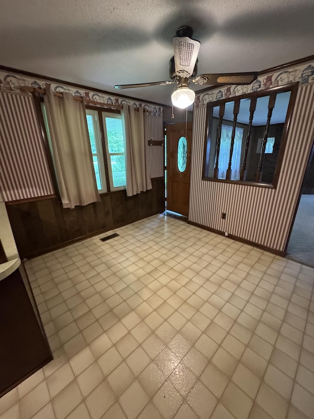 3911 Old Bottom Rd, Lafayette, TN 37083 - foyer entrance with a ceiling fan, a textured ceiling, and wood walls