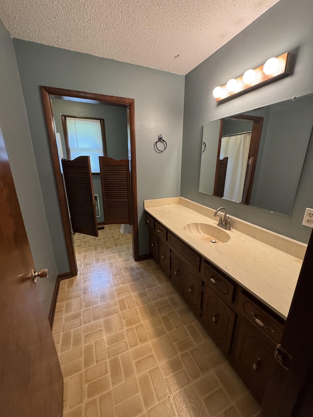 3911 Old Bottom Rd, Lafayette, TN 37083 - bathroom featuring brick patterned flooring, vanity, and a textured ceiling