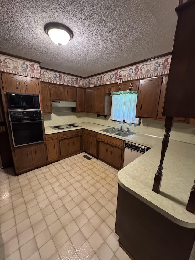 3911 Old Bottom Rd, Lafayette, TN 37083 - kitchen featuring black appliances, light countertops, a textured ceiling, under cabinet range hood, and dark brown cabinets