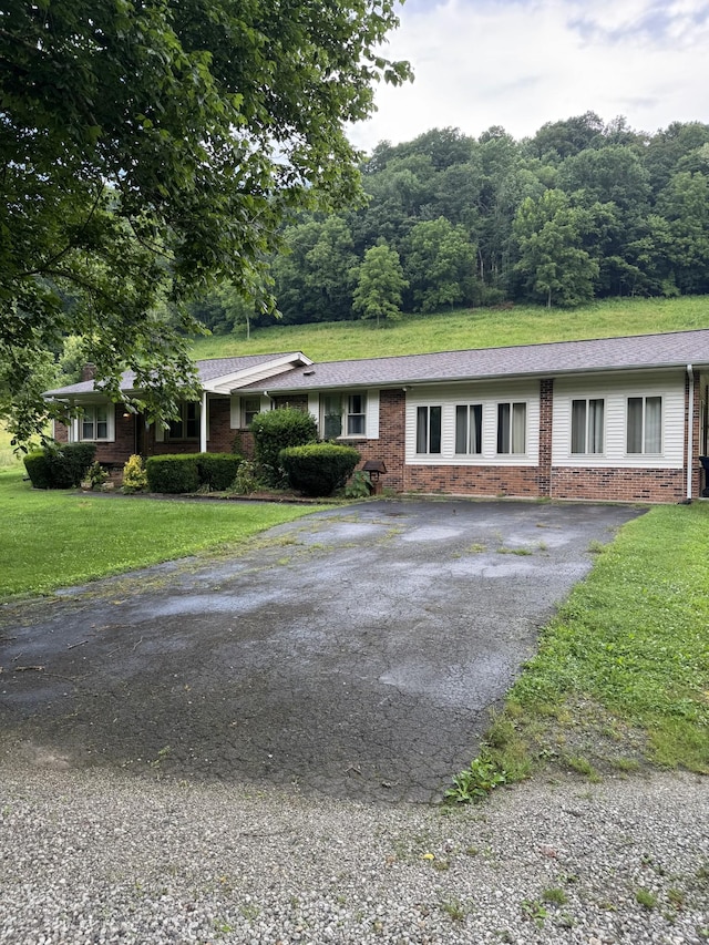 3911 Old Bottom Rd, Lafayette, TN 37083 - single story home featuring asphalt driveway, brick siding, and a front yard