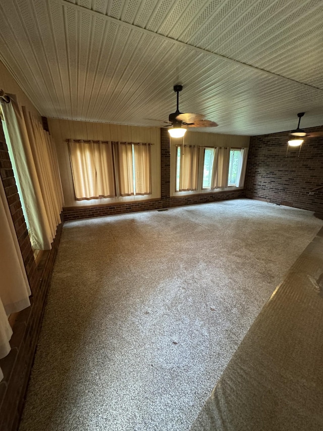 3911 Old Bottom Rd, Lafayette, TN 37083 - unfurnished room with brick wall, ceiling fan, and carpet flooring