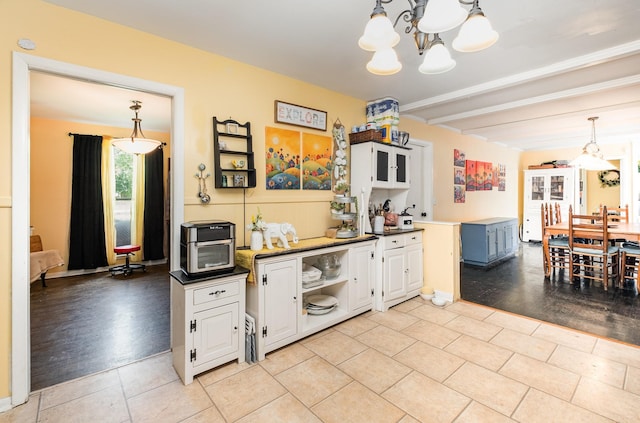 1211 Haber Dr, Brentwood, TN 37027 - kitchen with a chandelier, beamed ceiling, white cabinets, hanging light fixtures, and light tile patterned floors