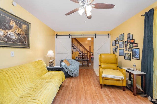 1211 Haber Dr, Brentwood, TN 37027 - living area featuring a barn door, wood finished floors, and ceiling fan