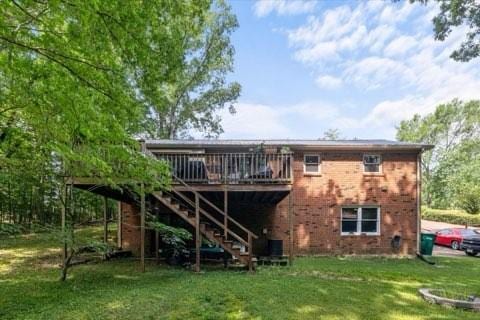 101 Cedar Hill Dr, Waverly, TN 37185 - back of property with a deck, brick siding, a yard, and stairway