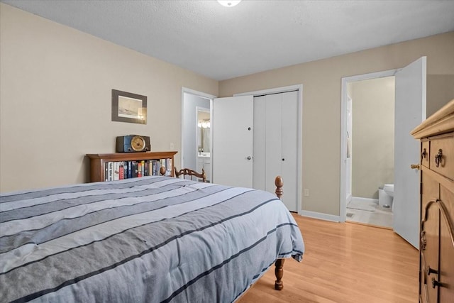 101 Cedar Hill Dr, Waverly, TN 37185 - bedroom with light wood-style flooring, a closet, and connected bathroom