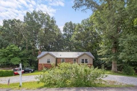 101 Cedar Hill Dr, Waverly, TN 37185 - ranch-style house featuring a chimney and a metal roof