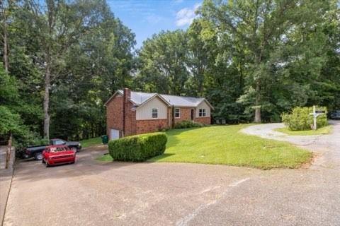 101 Cedar Hill Dr, Waverly, TN 37185 - ranch-style house with driveway, brick siding, a front yard, and a chimney