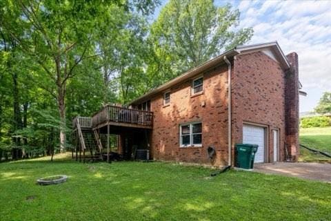 101 Cedar Hill Dr, Waverly, TN 37185 - rear view of property with a deck, driveway, stairs, a yard, and a garage