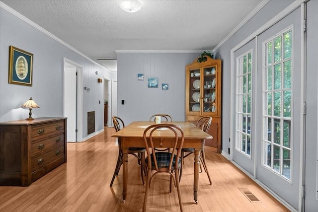 101 Cedar Hill Dr, Waverly, TN 37185 - dining space with crown molding, light wood-type flooring, and a textured ceiling