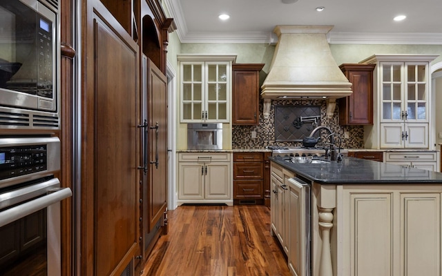 11 Saint Nicholas Way, Signal Mountain, TN 37377 - kitchen featuring custom range hood, appliances with stainless steel finishes, dark wood-type flooring, cream cabinetry, and crown molding