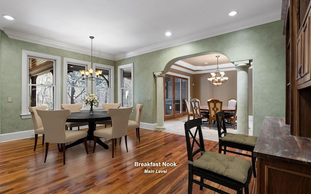 11 Saint Nicholas Way, Signal Mountain, TN 37377 - dining space with decorative columns, a chandelier, arched walkways, dark wood finished floors, and crown molding