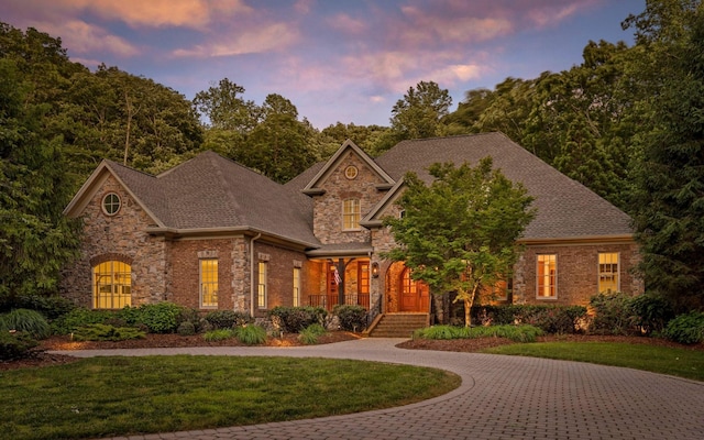 11 Saint Nicholas Way, Signal Mountain, TN 37377 - view of front of home with a front yard, covered porch, stone siding, a shingled roof, and brick siding