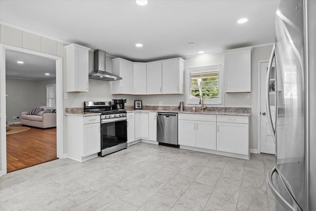 215 Sunset Dr, New Johnsonville, TN 37134 - kitchen with stainless steel appliances, wall chimney range hood, light stone countertops, white cabinetry, and recessed lighting