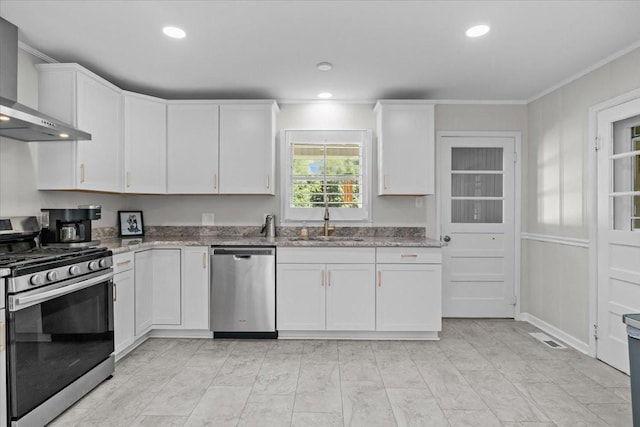 215 Sunset Dr, New Johnsonville, TN 37134 - kitchen featuring appliances with stainless steel finishes, wall chimney exhaust hood, ornamental molding, light stone countertops, and white cabinets