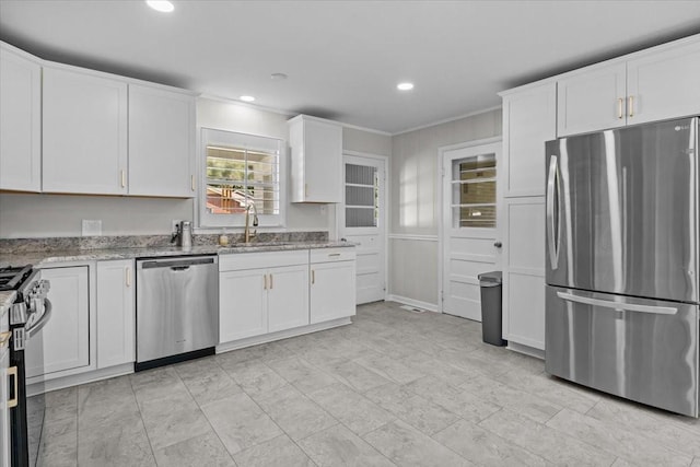 215 Sunset Dr, New Johnsonville, TN 37134 - kitchen featuring appliances with stainless steel finishes, white cabinets, light stone countertops, recessed lighting, and ornamental molding