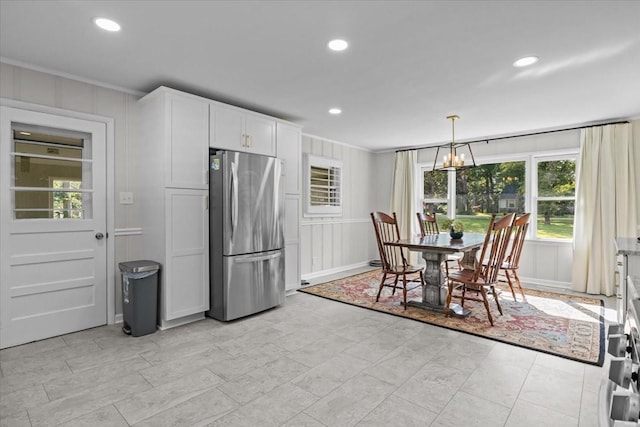 215 Sunset Dr, New Johnsonville, TN 37134 - kitchen with freestanding refrigerator, a decorative wall, crown molding, recessed lighting, and white cabinetry
