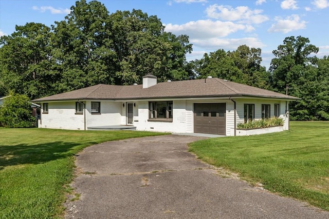 215 Sunset Dr, New Johnsonville, TN 37134 - ranch-style home with asphalt driveway, a garage, a chimney, and a front yard