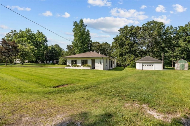215 Sunset Dr, New Johnsonville, TN 37134 - view of green lawn with a detached garage and a shed
