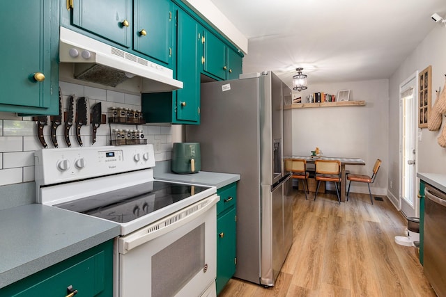 614 Joshua Dr, Clarksville, TN 37042 - kitchen featuring appliances with stainless steel finishes, under cabinet range hood, light wood-type flooring, and light countertops