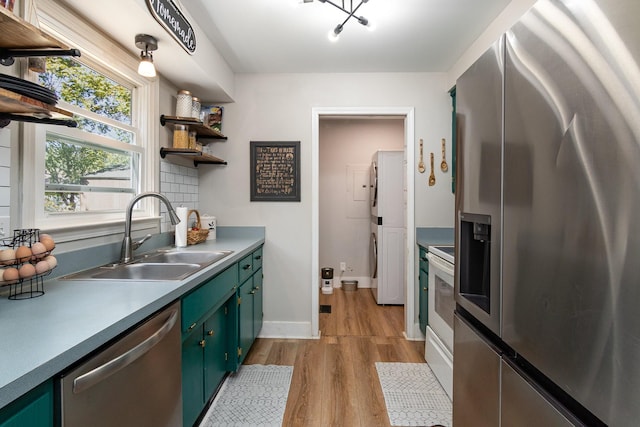 614 Joshua Dr, Clarksville, TN 37042 - kitchen with stainless steel appliances, green cabinetry, light wood-style flooring, open shelves, and tasteful backsplash