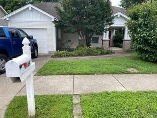 1869 Brookmeadow Ln, Hermitage, TN 37076 - view of front of home featuring a garage, board and batten siding, a front lawn, and driveway