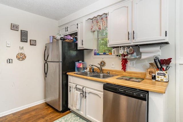 1205 Bloom Landing Rd, Charlotte, TN 37036 - kitchen with stainless steel appliances, white cabinetry, dark wood-style floors, butcher block countertops, and a textured ceiling