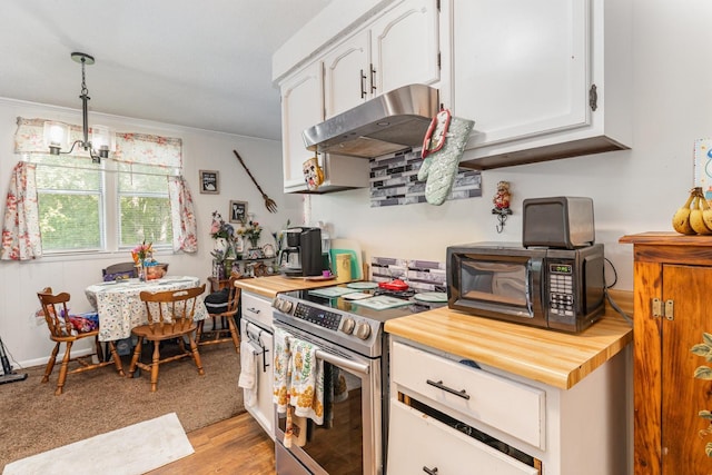 1205 Bloom Landing Rd, Charlotte, TN 37036 - kitchen with stainless steel electric stove, wood counters, under cabinet range hood, white cabinetry, and ornamental molding