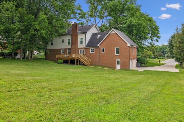 9214 Hunterboro Dr, Brentwood, TN 37027 - rear view of house with an attached garage, driveway, brick siding, stairs, and a lawn