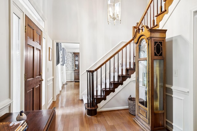 9214 Hunterboro Dr, Brentwood, TN 37027 - foyer entrance with a decorative wall, hardwood / wood-style flooring, stairway, a chandelier, and a wainscoted wall