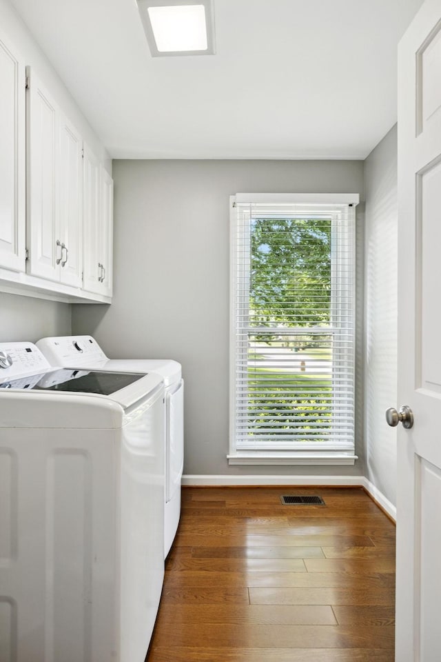 9214 Hunterboro Dr, Brentwood, TN 37027 - laundry room featuring washing machine and clothes dryer, cabinet space, and wood finished floors
