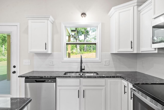 1220 Boulder Pass Rd, Clarksville, TN 37040 - kitchen featuring stainless steel appliances, white cabinetry, decorative backsplash, and dark stone counters