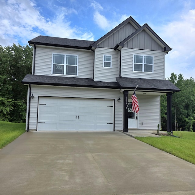 1204 Boulder Pass Rd, Clarksville, TN 37040 - view of front facade with an attached garage, board and batten siding, driveway, a front yard, and covered porch